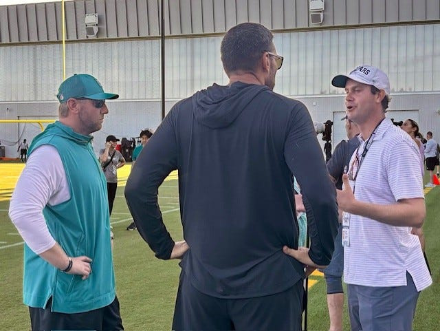PGA Tour player Harris English of St. Simons Island, Ga. (right) talks with Jacksonville Jaguars coach Liam Coen (left) and Vice-President of Football Operations Tony Boselli (center) during a Jaguars training camp practice on July 28 at the Miller Electric Center.