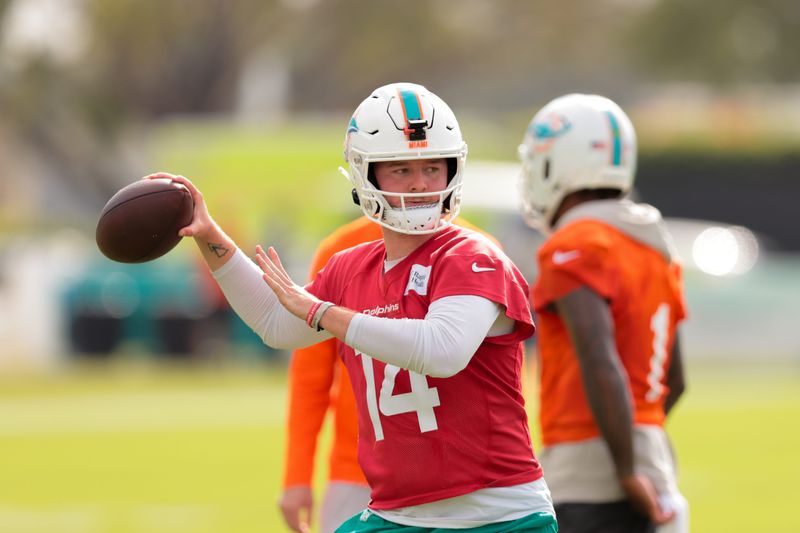 Jul 28, 2025; Miami Gardens, MI, USA; Miami Dolphins quarterback Quinn Ewers (14) throws the football during training camp at Baptist Health Training Complex. Mandatory Credit: Sam Navarro-Imagn Images