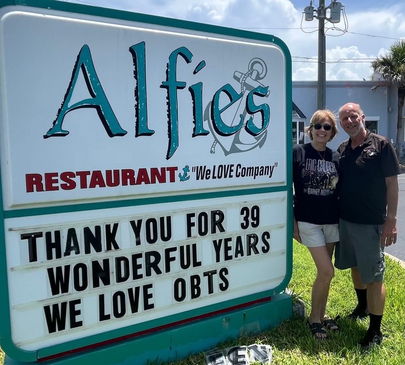 Dina and Greg Evans, owners of Alfie's Restaurant, pose for a photo outside the local fixture of nearly 40 years after announcing its recent closure.