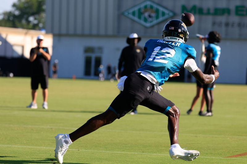 Jacksonville Jaguars wide receiver Travis Hunter (12) catches a pass during an NFL training camp session at the Miller Electric Center, Tuesday, July 29, 2025, in Jacksonville, Fla. [Corey Perrine/Florida Times-Union]