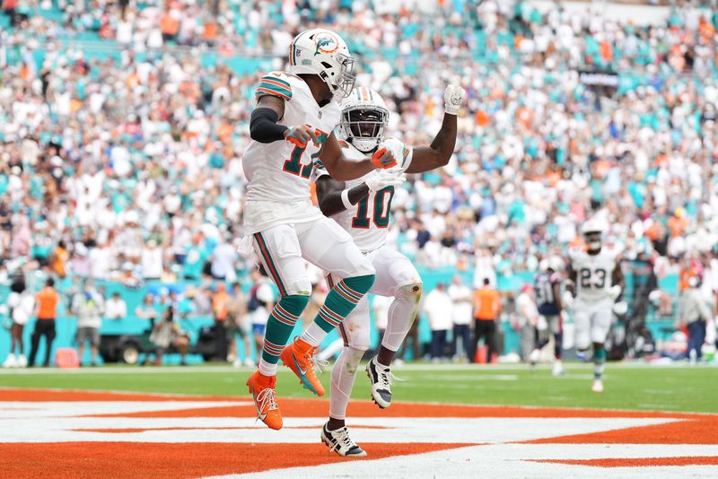 Oct 29, 2023; Miami Gardens, Florida, USA; Miami Dolphins wide receiver Jaylen Waddle (17) celebrates his touchdown against the New England Patriots with wide receiver Tyreek Hill (10) during the second half at Hard Rock Stadium. Mandatory Credit: Jasen Vinlove-USA TODAY Sports