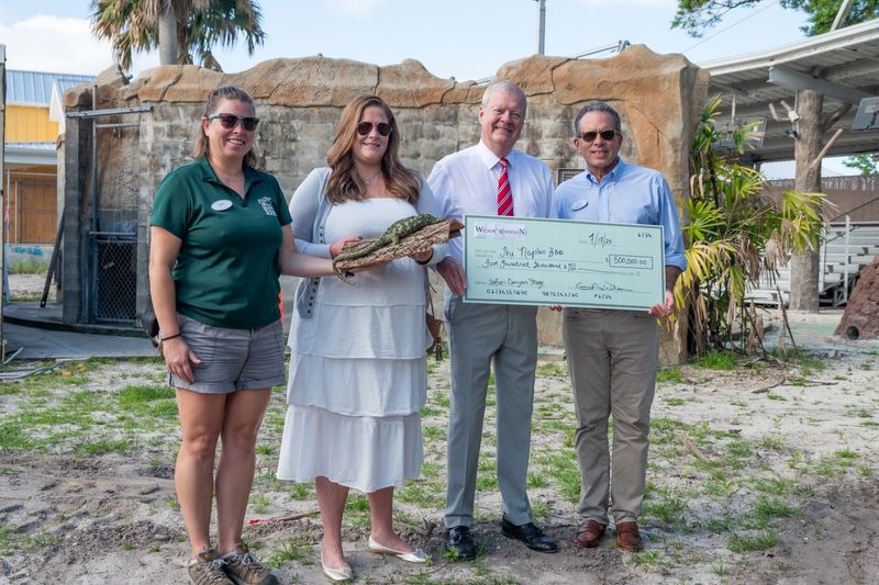 Left to right: Robin Ryan, animal operations manager for Naples Zoo; Whitney Wilson, Wilson & Johnson Private Foundation; George A. Wilson, Wilson & Johnson Private Foundation; and Jack Mulvena, president and CEO for Naples Zoo. The group posed with a $500,000 check. Submitted by Cone Communications