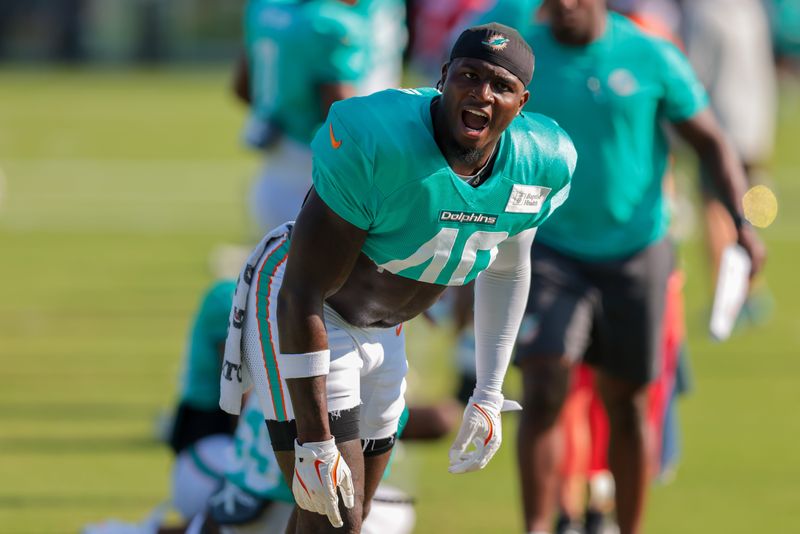 Jul 29, 2025; Miami Gardens, FL, USA; Miami Dolphins linebacker Willie Gay (40) reacts while stretching during training camp at Baptist Health Training Complex. Mandatory Credit: Sam Navarro-Imagn Images