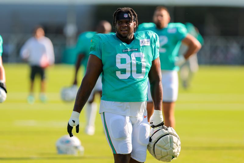 Jul 29, 2025; Miami Gardens, FL, USA; Miami Dolphins defensive tackle Kenneth Grant (90) looks on from the field during training camp at Baptist Health Training Complex. Mandatory Credit: Sam Navarro-Imagn Images