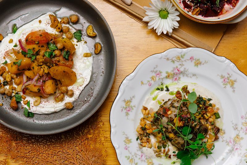 The Summer Melon + Labneh Plate (left) and Herb-Crusted Pork Tenderloin (right) are signature dishes at Bea's Fine Foods + All Day Cafe opening Aug. 13 at 9 Anastasia Blvd. on Anastasia Island, just south of the Bridge of Lions in St. Augustine.