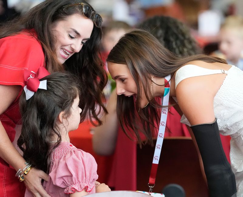 Aug. 5, 2025; Tuscaloosa, AL, USA; Lulu Gribbin, who as presented the Bigger Than The Game Award during the Nick’s Kids Foundation Luncheon at Bryant-Denny Stadium, talks to Lena Laney.