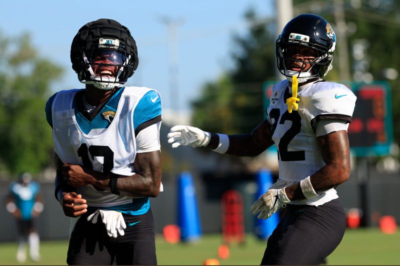 Jacksonville Jaguars wide receiver Travis Hunter (12) reacts during practices as cornerback Jarrian Jones (22) looks on during an NFL training camp session at the Miller Electric Center, Wednesday, Aug. 6, 2025, in Jacksonville, Fla. [Corey Perrine/Florida Times-Union]