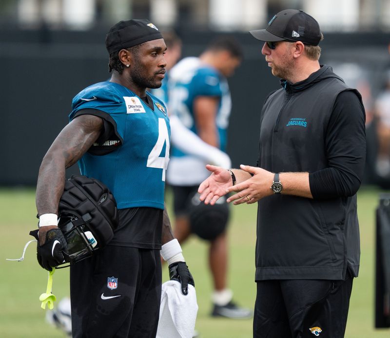 Jacksonville Jaguars running back Tank Bigsby (4) talks with Jacksonville Jaguars head coach Liam Coen after the Jaguar’s 12th NFL training camp session at the Miller Electric Center, Thursday, Aug. 7, 2025, in Jacksonville, Fla. [Doug Engle/Florida Times-Union]