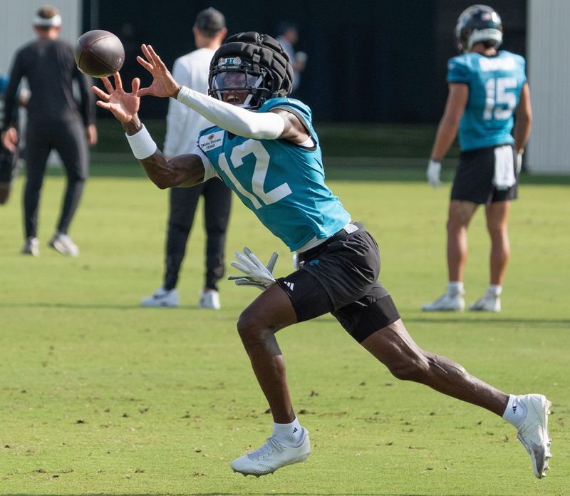 Jacksonville Jaguars wide receiver Travis Hunter (12) hauls in a pass while running a route during the Jaguarâ€™s 12th NFL training camp session at the Miller Electric Center, Thursday, Aug. 7, 2025, in Jacksonville, Fla. [Doug Engle/Florida Times-Union]