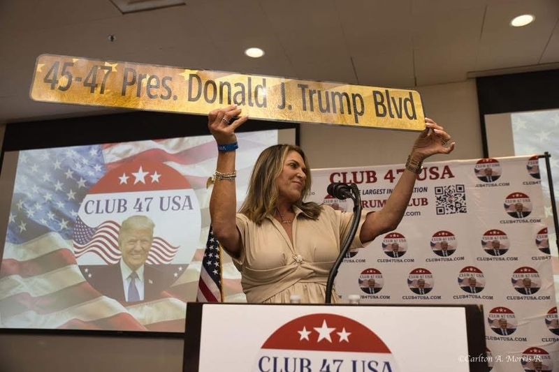 Florida State Rep. Meg Weinberger, R-Palm Beach Gardens, holds a decorative street sign commemorating a proposal to rename a stretch of Southern Boulevard as President Donald J. Trump Boulevard. Weinberger filed the original bill proposing the road-renaming.