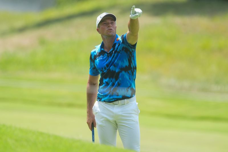 Viktor Hovland points to a possible path through the trees for his approach shot on the ninth hole during the first round of the FedEx St. Jude Championship at TPC Southwind in Memphis, Tenn., on August 7, 2025.