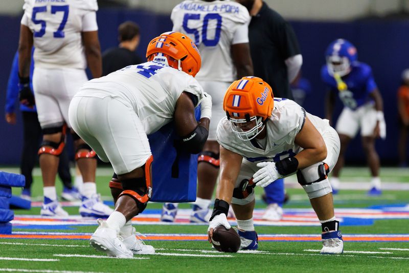 Florida Gators offensive lineman Noel Portnjagin (74) and Florida Gators offensive lineman Hayden Clem (59) run a drill during fall football practice at Sanders Indoor Practice Fields at the University of Florida in Gainesville, FL on Thursday, August 7, 2025. [Matt Pendleton/Gainesville Sun]