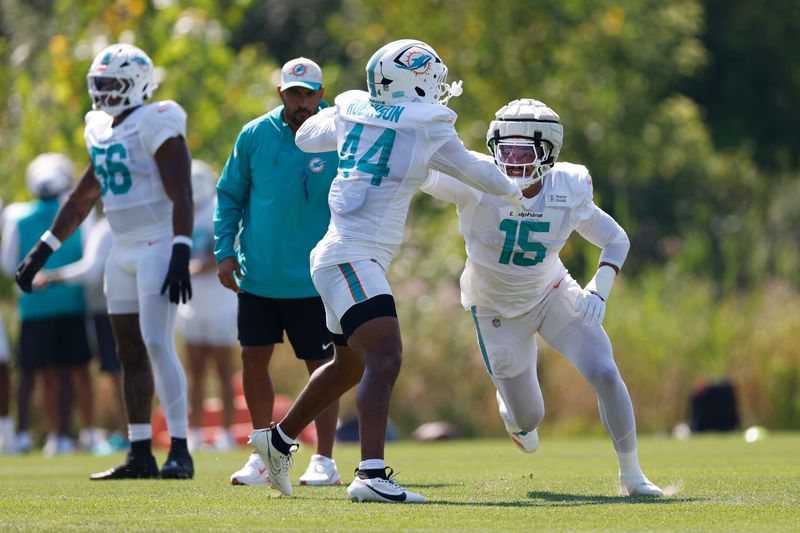 Aug 8, 2025; Lake Forest, IL, USA; Miami Dolphins linebacker Chop Robinson (44) and linebacker Jaelan Phillips (15) run on the field before joint training camp practice with the Chicago Bears ahead of Sunday's preseason opener. Mandatory Credit: Kamil Krzaczynski-Imagn Images