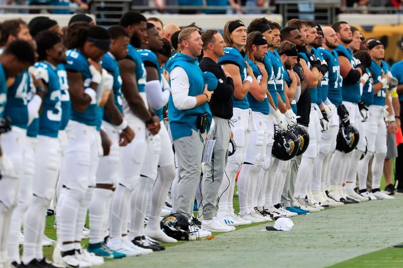 Jacksonville Jaguars quarterback Trevor Lawrence (16) llooks on during the national anthem before an NFL preseason matchup against the Pittsburgh Steelers at EverBank Stadium, Saturday, Aug. 9, 2025 in Jacksonville, Fla. [Corey Perrine/Florida Times-Union]