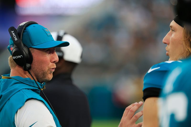 Jacksonville Jaguars head coach Liam Coen talks with quarterback Trevor Lawrence (16) during the second quarter of an NFL preseason matchup at EverBank Stadium, Saturday, Aug. 9, 2025 in Jacksonville, Fla. [Corey Perrine/Florida Times-Union]