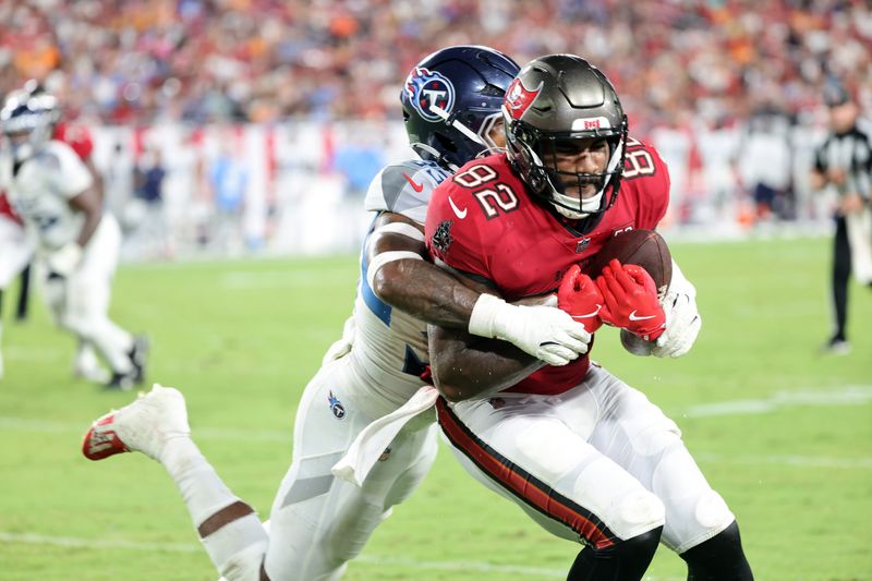 Aug 9, 2025; Tampa, Florida, USA; Tampa Bay Buccaneers tight end Devin Culp (82) runs with the ball as Tennessee Titans safety Kendell Brooks (33) tackles during the first half at Raymond James Stadium. Mandatory Credit: Kim Klement Neitzel-Imagn Images