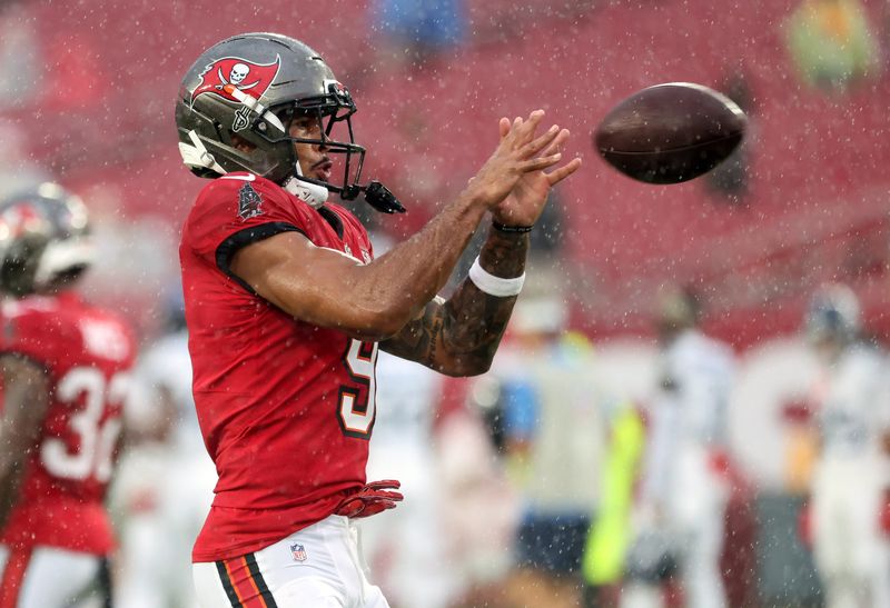Aug 9, 2025; Tampa, Florida, USA; Tampa Bay Buccaneers wide receiver Emeka Egbuka (9) works out prior to the game against the Tennessee Titians at Raymond James Stadium. Mandatory Credit: Kim Klement Neitzel-Imagn Images