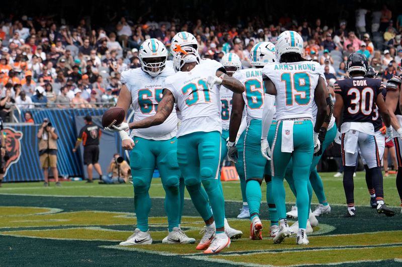 Aug 10, 2025; Chicago, Illinois, USA; Miami Dolphins running back Ollie Gordon II (31) celebrates his touchdown against the Chicago Bears during the second half at Soldier Field. Mandatory Credit: David Banks-Imagn Images