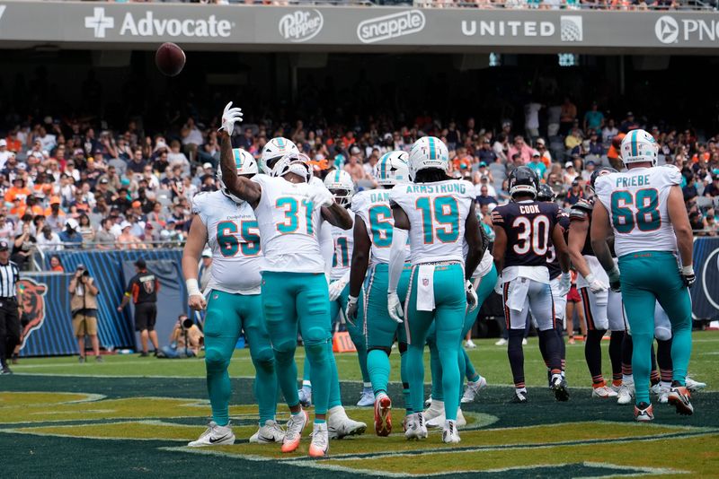 Aug 10, 2025; Chicago, Illinois, USA; Miami Dolphins running back Ollie Gordon II (31) celebrates his touchdown against the Chicago Bears during the second half at Soldier Field. Mandatory Credit: David Banks-Imagn Images