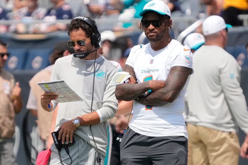 Aug 10, 2025; Chicago, Illinois, USA;Miami Dolphins head coach Mike McDaniels with quarterback Tua Tagovailoa (1) on thee sidelines during the second half of a game against the Chicago Bears at Soldier Field. Mandatory Credit: David Banks-Imagn Images