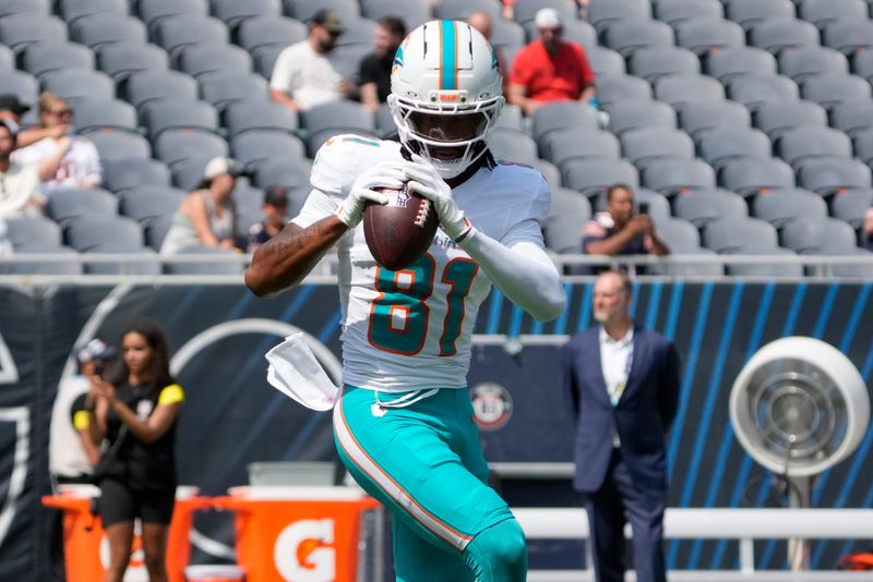 Aug 10, 2025; Chicago, Illinois, USA; Miami Dolphins wide receiver Theo Wease Jr. (81) warms up before the game against the Chicago Bears at Soldier Field. Mandatory Credit: David Banks-Imagn Images