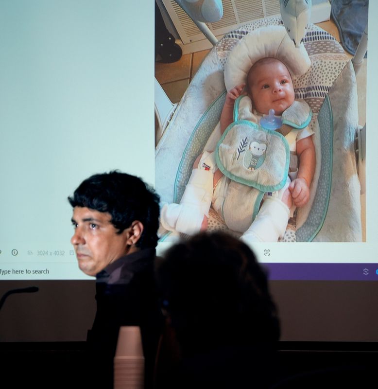 Peter Scheip gets tears in his eyes as he testifies about a photograph he took showing his son, Domninic, appearing happy despite being in leg braces after it was discovered his leg was broken. Scheip’s wife, Lily Scheip, is on trial for second-degree murder for the death of her 14-week old son in 2021.