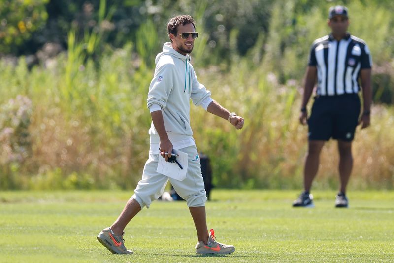Aug 8, 2025; Lake Forest, IL, USA; Miami Dolphins head coach Mike McDaniel walks on the field during joint training camp practice with the Chicago Bears ahead of Sunday's preseason opener. Mandatory Credit: Kamil Krzaczynski-Imagn Images