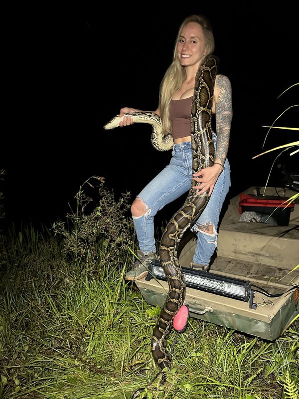 Taylor Stanberry, 29, of Naples, has hunted Burmese pythons for 10 years. She is the grand prize winner of the 2025 Florida Python Challenge with a total of 60 snakes nabbed during the competition.