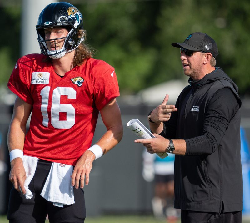 Jacksonville Jaguars quarterback Trevor Lawrence gets coached by Liam Coen during the Jaguars training camp.