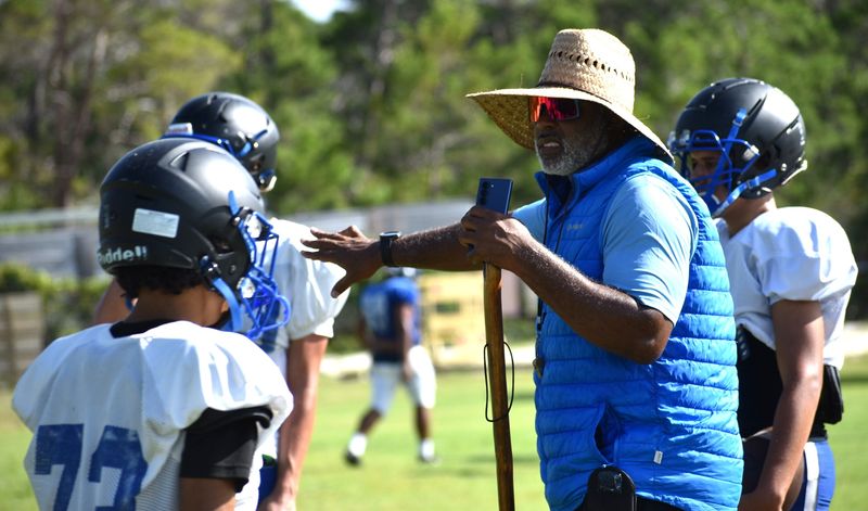 Destin High Coach E.G. Green gives instruction during practice on Aug. 12. The Sharks open on Aug. 22 at 7 p.m. at home against Northview. The Sharks play at the Destin Middle School football field.