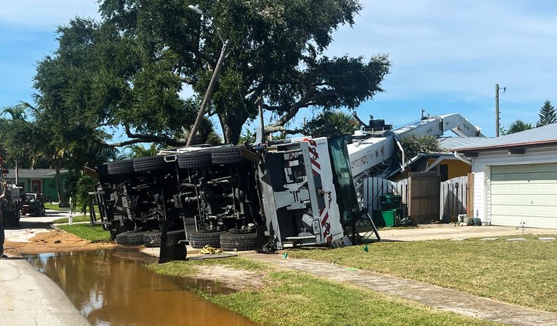 A crane used to remove telephone poles crashed into a Merritt Island residence on Aug. 13 as the homeowner, Jim Crane, watched from the driveway.