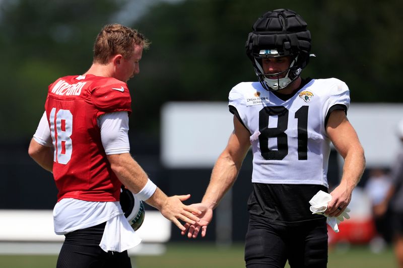 Jacksonville Jaguars quarterback John Wolford (18) high-fives wide receiver Austin Trammell (81) after an NFL training camp session at the Miller Electric Center, Thursday, Aug. 14, 2025 in Jacksonville, Fla.