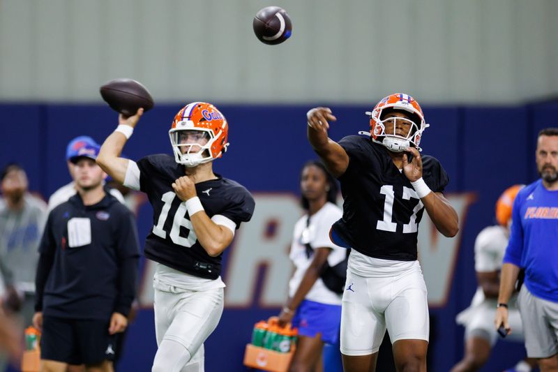 Florida Gators quarterback Tramell Jones Jr. (17) and Florida Gators quarterback Aidan Warner (16) throw the ball during fall football practice at Sanders Indoor Practice Facility at the University of Florida in Gainesville, FL on Thursday, August 14, 2025. [Matt Pendleton/Gainesville Sun]