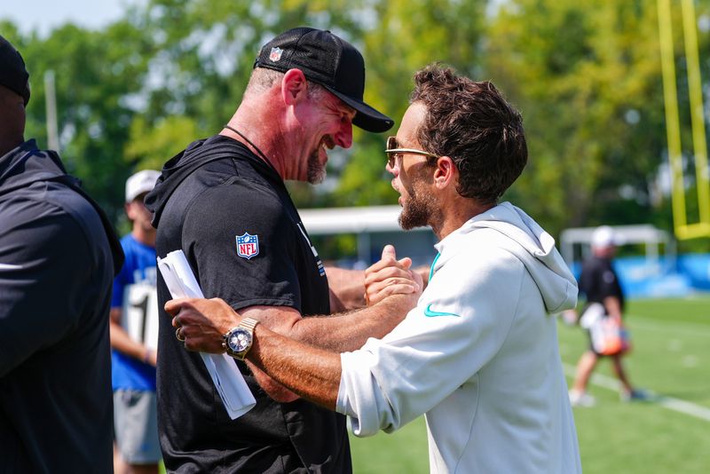 Detroit Lions coach Dan Campbell shakes hands with Miami Dolphins coach Mike McDaniels after a joint practice at Lions headquarters and training facility in Allen Park, Thursday, Aug. 14, 2025.