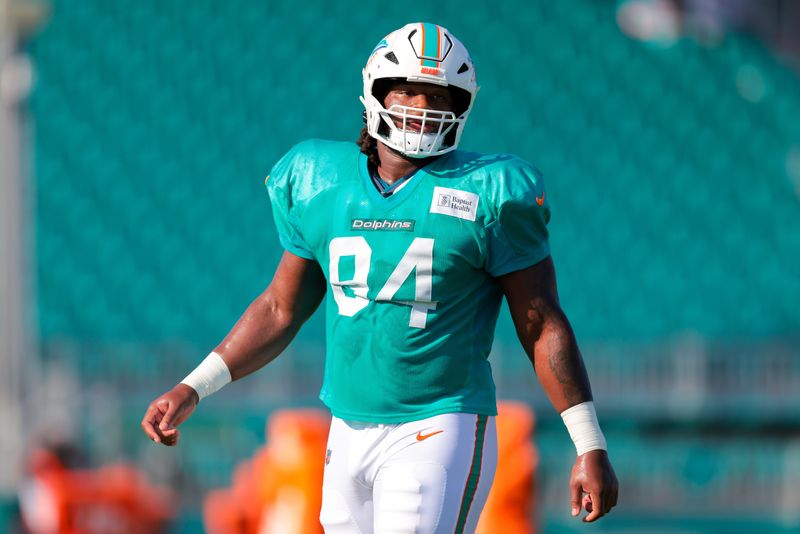 Jul 29, 2025; Miami Gardens, FL, USA; Miami Dolphins defensive tackle Jordan Phillips (94) looks on from the field during training camp at Baptist Health Training Complex. Mandatory Credit: Sam Navarro-Imagn Images