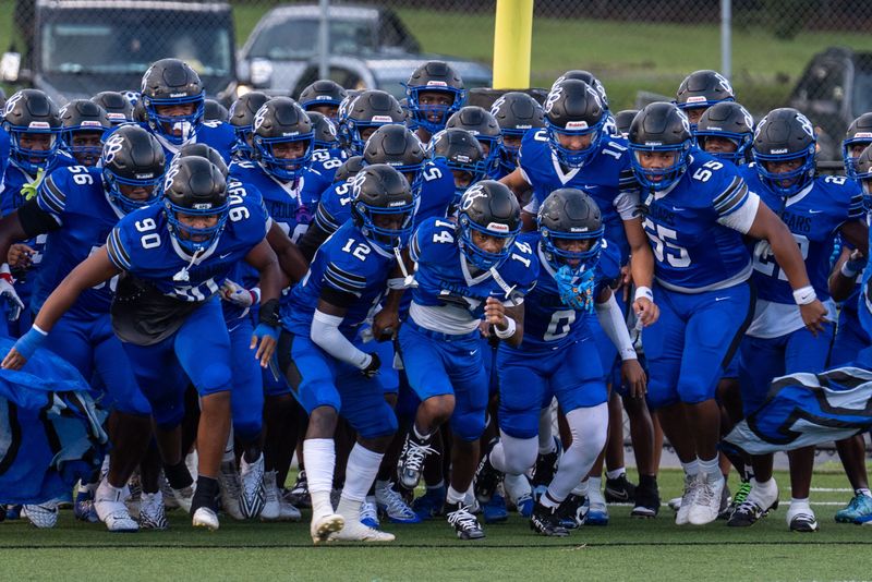 Godby Cougars football team storms onto the field for a preseason game Thursday, Aug. 14, 2025.