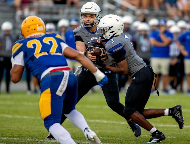 Lakeland Christian Brody Brenneman fakes a handoff to running back AJ Truedell against Auburndale on Friday night at Bruce Canova Stadium.