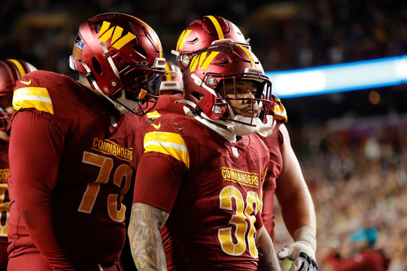 Dec 29, 2024; Landover, Maryland, USA; Washington Commanders running back Chris Rodriguez Jr. (36) celebrates after scoring a touchdown during the second half against the Atlanta Falcons at Northwest Stadium. Mandatory Credit: Amber Searls-Imagn Images