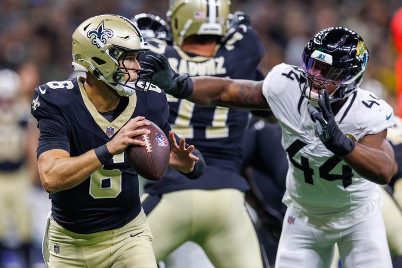 Aug 17, 2025; New Orleans, Louisiana, USA; New Orleans Saints quarterback Tyler Shough (6) is chased out the pocket by Jacksonville Jaguars defensive end Travon Walker (44) during the first half at Caesars Superdome. Mandatory Credit: Stephen Lew-Imagn Images