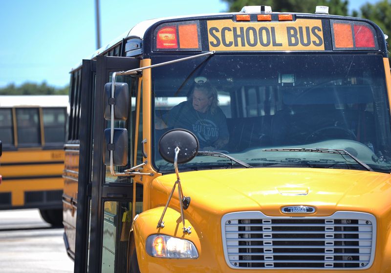 Martin County school bus driver Evonne Eicher checks her bus before heading out from the bus compound on Aug. 15, 2025, in Stuart. Eicher was named Florida School Bus Driver of the Year for 2025.