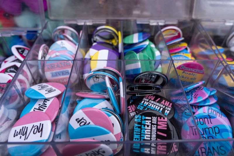 Transgender flag and pronoun buttons are seen for sale during 2025 PrideFest in Des Moines, Iowa. Sheila Weiss, president of PFLAG Sarasota, writes that Sarasota's transgender community needs to feel supported.