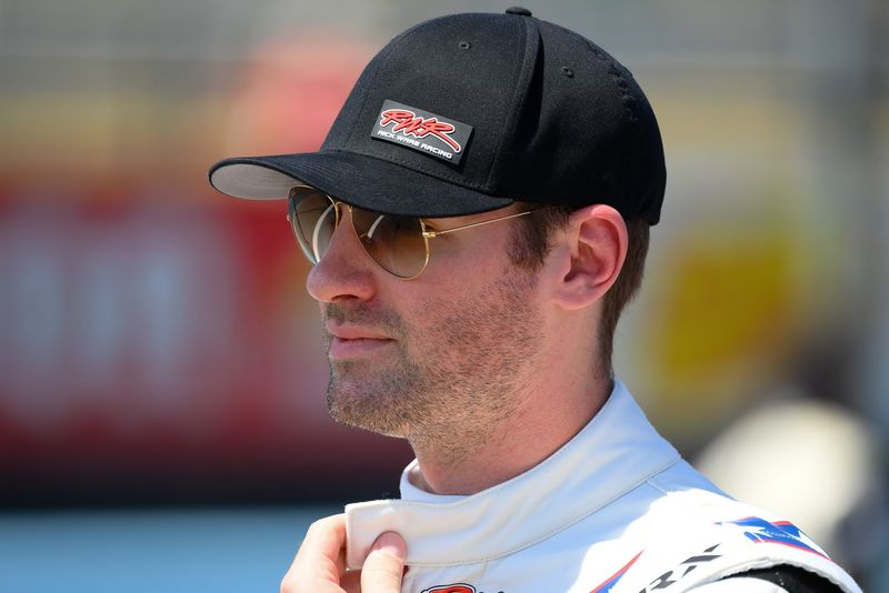 Aug 10, 2025; Watkins Glen, New York, USA; NASCAR Cup Series driver Cody Ware (51) walks on the grid prior to the Go Bowling at The Glen at Watkins Glen International. Mandatory Credit: Rich Barnes-Imagn Images