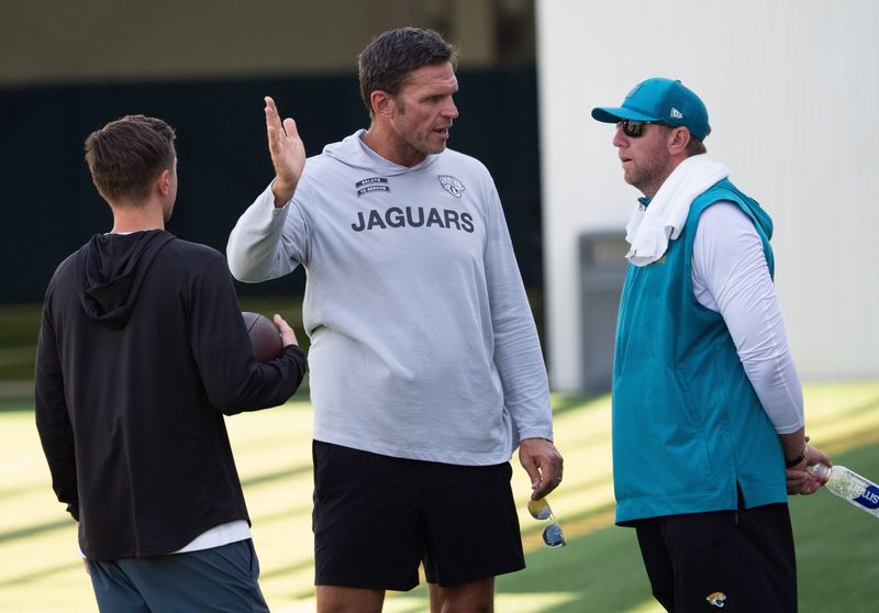 Jacksonville Jaguars General Manager James Gladstone, left and Jaguars Executive Vice President of Football Operations Tony Boselli, center, all talk with Jacksonville Jaguars Head Coach Liam Coen after the Jacksonville Jaguarsâ€™ 18th and final training camp practice at Miller Electric Center in Jacksonville, Fla. Wednesday August 20, 2025. [Doug Engle/Florida Times-Union]