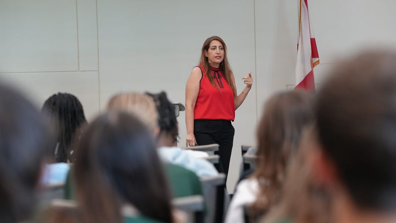 Debbie Rahamim, a Chase community manager who conducts financial awareness seminars, speaks to Palm Beach State student-athletes about the dangers of NIL scams.