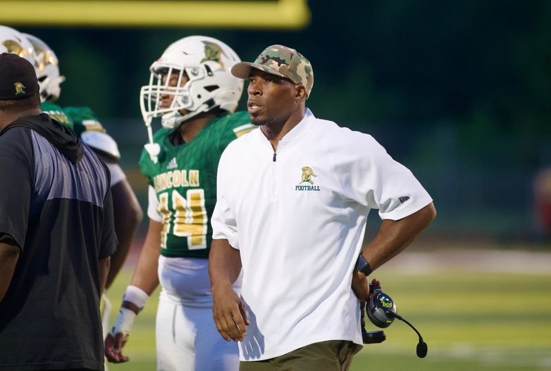 Lincoln football head coach Matt Jackson during a timeout as the Trojans beat Niceville 36-29 on Friday Aug. 22, 2025 at Chiles High School