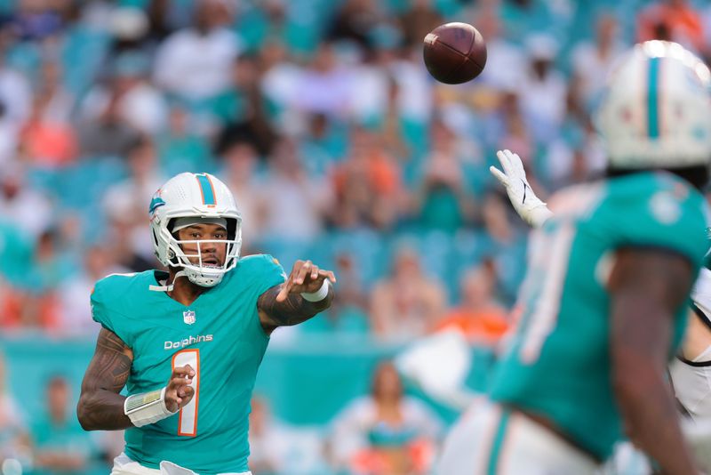 Aug 23, 2025; Miami Gardens, Florida, USA; Miami Dolphins quarterback Tua Tagovailoa (1) passes the football against the Jacksonville Jaguars during the first quarter at Hard Rock Stadium. Mandatory Credit: Sam Navarro-Imagn Images