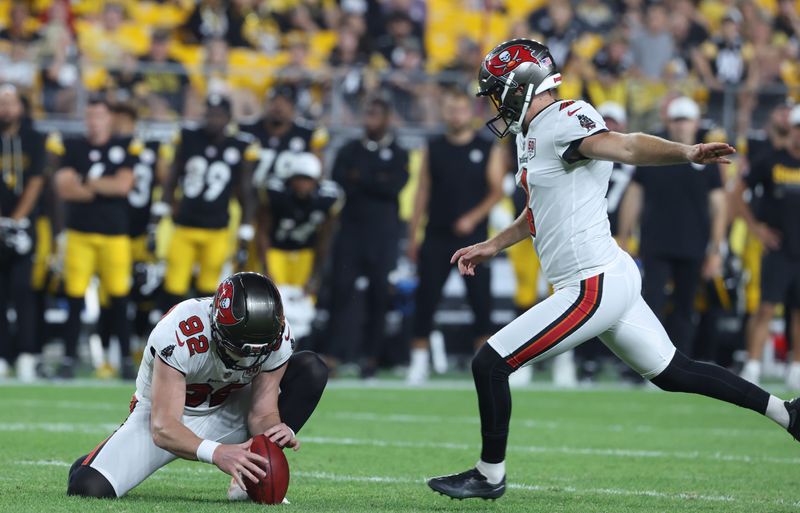 Aug 16, 2025; Pittsburgh, Pennsylvania, USA; Tampa Bay Buccaneers place kicker Chase McLaughlin (right) kicks the game winning g field goal from the hold of punter Riley Dixon (92) as time expires to defeat the Pittsburgh Steelers at Acrisure Stadium. Mandatory Credit: Charles LeClaire-Imagn Images