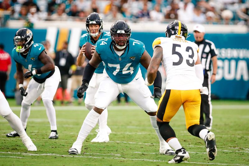 Aug 9, 2025; Jacksonville, Florida, USA; Jacksonville Jaguars offensive tackle Fred Johnson (74) prepares to block a rusher against the Pittsburgh Steelers during a preseason game at EverBank Stadium. Mandatory Credit: Travis Register-Imagn Images