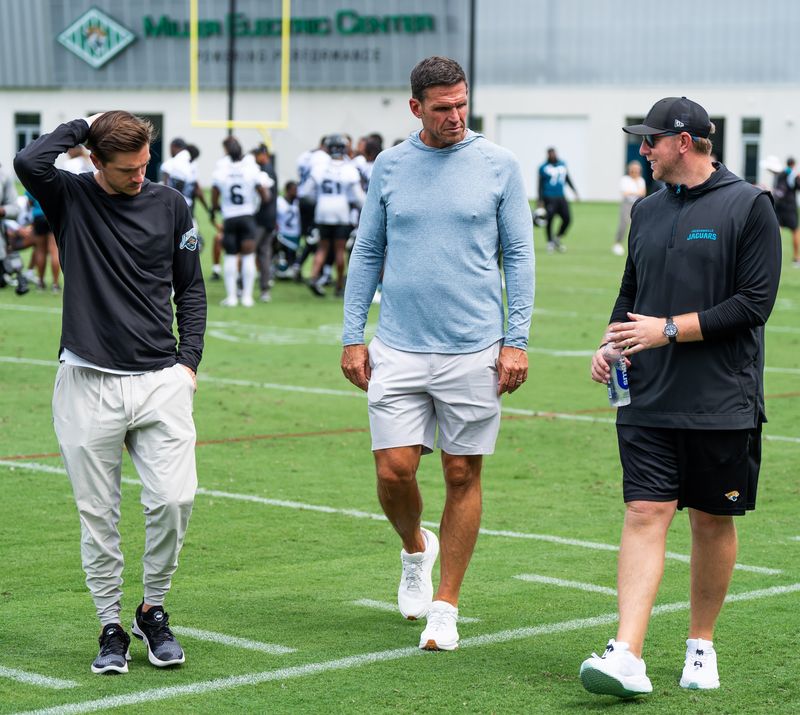 Jacksonville Jaguars general manager James Gladstone, left, Jacksonville Jaguars is executive vice president of football operations Tony Boselli, center and Jacksonville Jaguars head coach Liam Coen, right, all talk on the field after the Jacksonville Jaguarsâ€™ mandatory minicamp Tuesday June 10, 2025 at the Miller Electric Center in Jacksonville, Fla. [Doug Engle/Florida Times-Union]