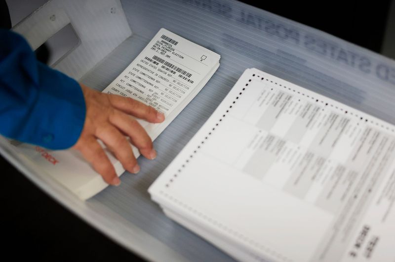 Mock ballots are picked up by Robert Phillips to screen on a DS300 during a public testing of the automated tabulating voting equipment hosted by the Duval County Supervisor of Elections Office Thursday, July 25, 2024 in Jacksonville, Fla. The test, required by law, verifies full accuracy of the equipment in the upcoming Aug. 20 primary election.
